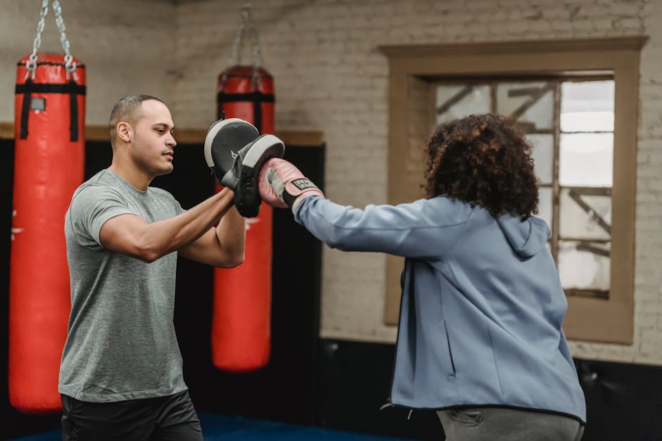 Muita lisäpalveluita Boxing training indoors with coach guiding punch techniques to trainee.